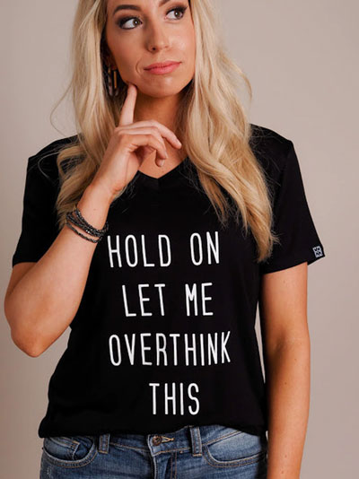 Woman models black “Let Me Overthink This” graphic t-shirt