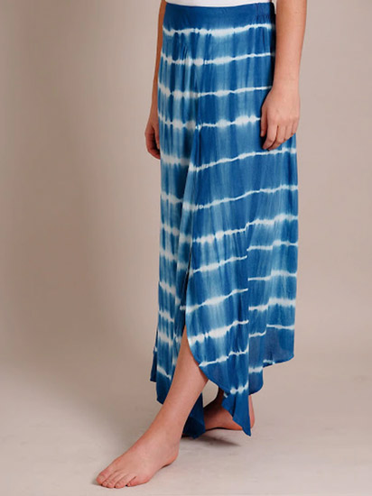 A woman models a blue tie-dye skirt as a casual spring outfit.