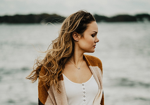 woman in a cardigan on the beach