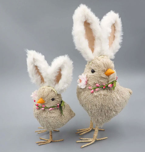 Two rustic straw chick figurines with large rabbit ears.