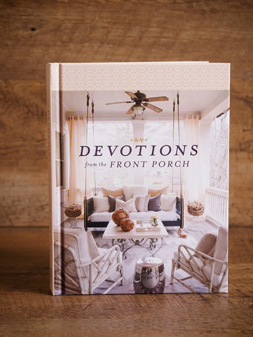 A copy of “Devotions From the Front Porch” posed on a wooden surface.