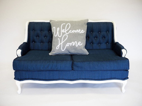  A gray pillow modeled on a couch as an example of rustic spring decor.
