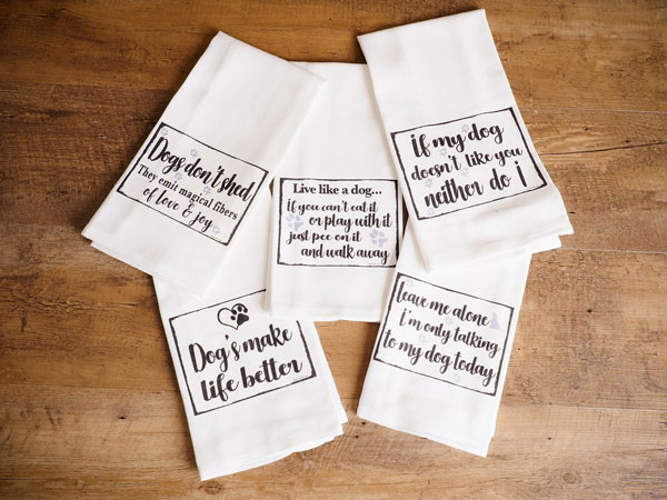 A collection of tea towels with cute slogans as an example of popular home decor trends in 2020.