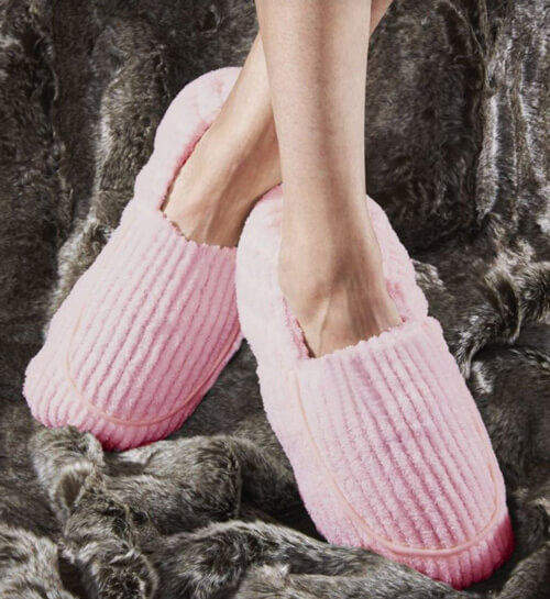 close up of pair of feet in pink slippers