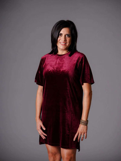 A woman models a red velvet short sleeve casual boutique dress