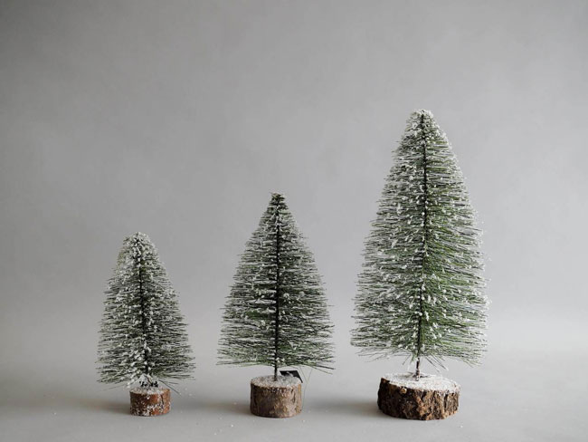 Three, faux snow-frosted Christmas tree rustic farmhouse Christmas decorations.