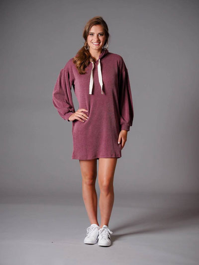 A woman models a pink, sweatshirt casual boutique dress