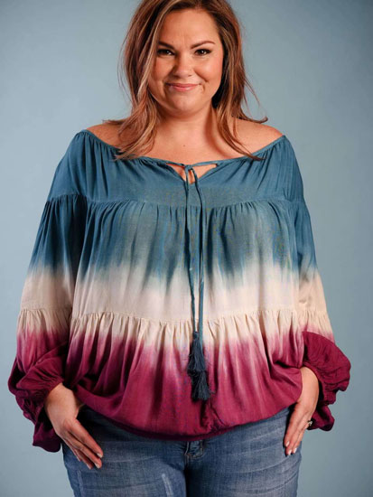 A woman models a boho, red, white, and blue boho plus size boutique shirt.