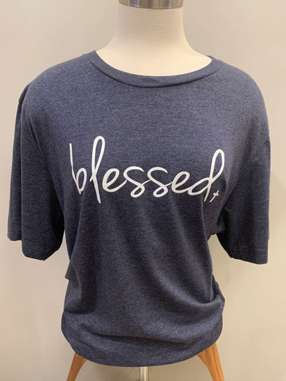 A mannequin models a blue “blessed” plus size boutique t-shirt.