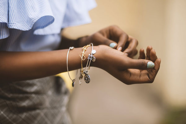Woman models her dainty bracelets and other minimalist 