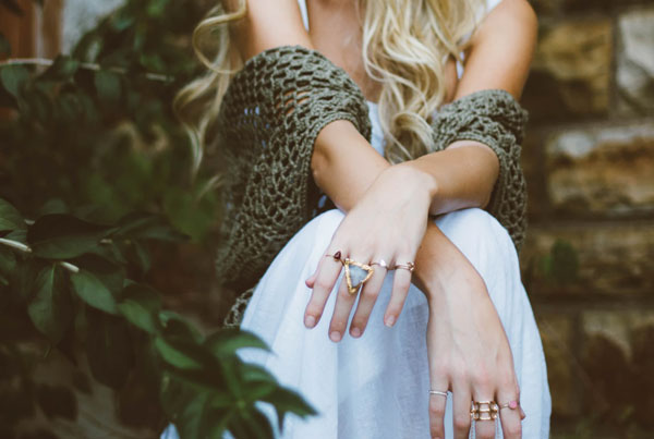 A women models her collection of rings and other minimalist accessories.